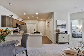 an open kitchen and living room with a couch and a table  at Aventura at Hawk Ridge, Missouri, 63367